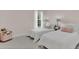 Bedroom with two twin-sized beds and a pink accent at 258 Padgett Pl S, Lakeland, FL 33809