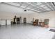 Spacious garage with tiled floor, washer, dryer and rocking chairs at 258 Padgett Pl S, Lakeland, FL 33809