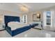 Spacious main bedroom with a large, blue upholstered bed at 258 Padgett Pl S, Lakeland, FL 33809