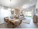 Bright dining room with a wooden table and wicker chairs at 559 Sw 77Th Cir, Ocala, FL 34474