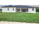 Single story home with a covered patio and lush lawn at 1001 Cody Bluffs Rd, Babson Park, FL 33827