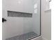 Shower with unique penny round tile detail and glass enclosure at 1001 Cody Bluffs Rd, Babson Park, FL 33827