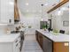 Modern kitchen with white cabinets, wood accents, and stainless steel appliances at 1001 Cody Bluffs Rd, Babson Park, FL 33827
