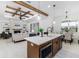 Open kitchen with island, stainless steel appliances, and views into the living room at 1001 Cody Bluffs Rd, Babson Park, FL 33827