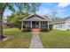 Cute bungalow features a covered porch and well-manicured lawn at 1121 Josephine St, Lakeland, FL 33815