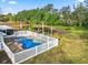 Home with a fenced backyard, pool, and palm trees at 3445 Ewell Rd, Lakeland, FL 33811