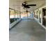 Large screened porch with concrete flooring and ceiling fans at 3445 Ewell Rd, Lakeland, FL 33811