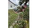Landscaped side yard with blooming flowers and a stone pathway at 5982 Crane Dr, Lakeland, FL 33809