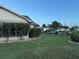 Side yard with lush grass, shrubs, and a view of the neighborhood at 5982 Crane Dr, Lakeland, FL 33809