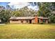 Brick ranch house with large yard and mature trees at 7206 Ranch Rd, Lakeland, FL 33809