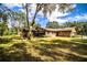 Landscaped backyard with a large tree and screened-in porch at 7206 Ranch Rd, Lakeland, FL 33809