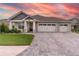 Two-story home with three-car garage and stone accents at 7929 Lake James Blvd, Lakeland, FL 33810