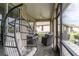 Relaxing screened patio with hanging chair and seating at 7929 Lake James Blvd, Lakeland, FL 33810