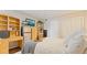 Spacious bedroom with a queen bed, dresser, and mini-fridge at 1 Loma Linda, Lakeland, FL 33813