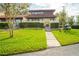 Attractive home exterior with manicured lawn and walkway at 1 Loma Linda, Lakeland, FL 33813