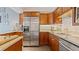 Well-equipped kitchen with wood cabinets and granite counters at 1 Loma Linda, Lakeland, FL 33813