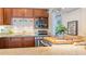 Well-equipped kitchen with wood cabinets and granite countertops at 1 Loma Linda, Lakeland, FL 33813