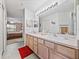 Double vanity bathroom with light wood cabinets at 1057 Canary Cir N, Lakeland, FL 33809