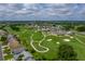 Aerial view of community with golf course, homes, and clubhouse at 1057 Canary Cir N, Lakeland, FL 33809