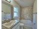 Bathroom with tub, shower, and granite vanity at 1213 Tagliamento Ln, Haines City, FL 33844