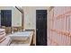 Bathroom boasts granite countertop, a white sink, and a pink shower curtain at 1215 Cypress E Pt, Winter Haven, FL 33884
