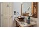 Chic bathroom with a vessel sink and ornate mirror at 1215 Cypress E Pt, Winter Haven, FL 33884