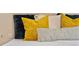 Close-up view of pillows in blue and gold hues on a bed at 1215 Cypress E Pt, Winter Haven, FL 33884
