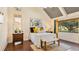 Bright bedroom with wood floors, a queen bed, and access to a private patio at 1215 Cypress E Pt, Winter Haven, FL 33884