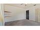 Bedroom with grey carpet, built-in corner shelves, and a window at 1215 Cypress E Pt, Winter Haven, FL 33884