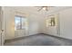 Bright bedroom with grey carpet and two windows with white curtains at 1215 Cypress E Pt, Winter Haven, FL 33884