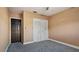 Bedroom with gray carpet, double closet, and dark door at 1215 Cypress E Pt, Winter Haven, FL 33884