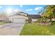 White two-story house with a two-car garage and landscaped lawn at 1215 Cypress E Pt, Winter Haven, FL 33884