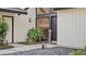View of the front entrance with dark double doors and landscaping at 1215 Cypress E Pt, Winter Haven, FL 33884