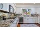 Modern kitchen with granite countertops and stainless steel appliances at 1215 Cypress E Pt, Winter Haven, FL 33884