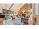 Living area features a stone fireplace, vaulted ceilings, and adjacent access to the pool at 1215 Cypress E Pt, Winter Haven, FL 33884
