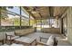 Relaxing screened porch with wooden ceiling, seating area, and pool view at 1215 Cypress E Pt, Winter Haven, FL 33884