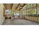 Relaxing screened porch with wood ceiling and comfortable seating at 1215 Cypress E Pt, Winter Haven, FL 33884