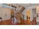 View of a wooden staircase with terracotta floor and a half bathroom at 1215 Cypress E Pt, Winter Haven, FL 33884