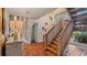 Elegant wooden staircase in a spacious foyer with terracotta tile flooring at 1215 Cypress E Pt, Winter Haven, FL 33884