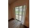 Bright interior room featuring a sliding glass door with vertical blinds leading to a screened patio at 1264 Dosseywood Ln, Lakeland, FL 33811