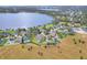 Aerial view of home and neighborhood by lake at 1935 Austin Ter, Winter Haven, FL 33884