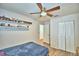 Bright bedroom with ceiling fan, wood-look floors, and ample closet space at 384 Winter Ridge Blvd, Winter Haven, FL 33881