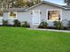 Charming house with gray siding and manicured lawn at 5225 Golden Gate Blvd, Polk City, FL 33868