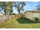 Large backyard with detached workshop and wooden fence at 5860 E Starling Dr, Mulberry, FL 33860