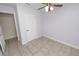 Bedroom with tile floors, ceiling fan, and closet at 5860 E Starling Dr, Mulberry, FL 33860