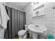 Bathroom with white subway tiles and pedestal sink at 855 Candyce Ave, Lakeland, FL 33815