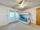 Bedroom with bunk bed, carpet flooring, and access to a patio at 92 Wood Hall Dr, Mulberry, FL 33860