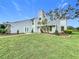 Two-story house with attached garage and manicured lawn at 92 Wood Hall Dr, Mulberry, FL 33860