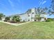Two-story house with attached garage and manicured lawn at 92 Wood Hall Dr, Mulberry, FL 33860