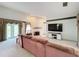 Spacious living room featuring a fireplace and large TV at 92 Wood Hall Dr, Mulberry, FL 33860